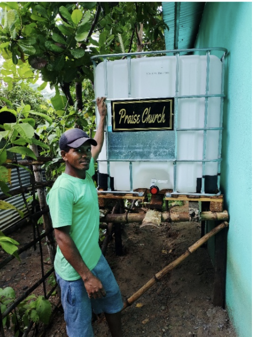 Community member with the completed clean water system