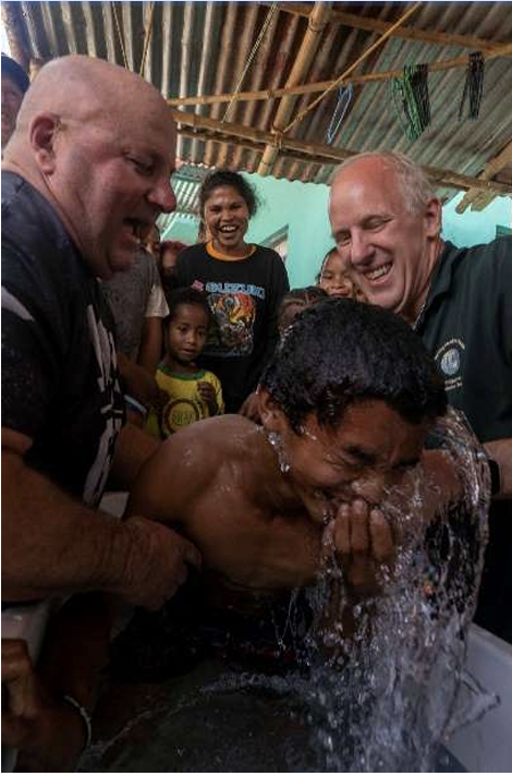 Community member being baptized