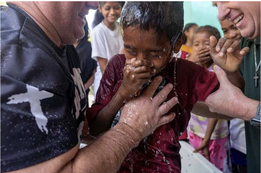Another community member being baptized