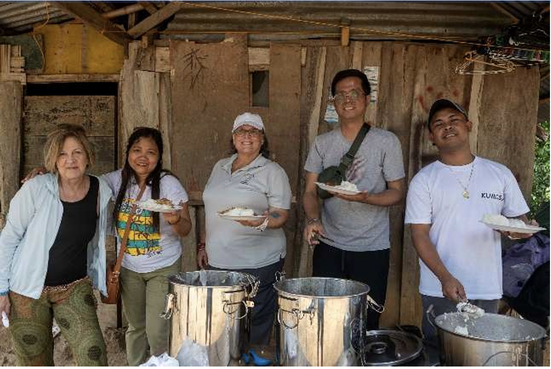 Mission team members serving food