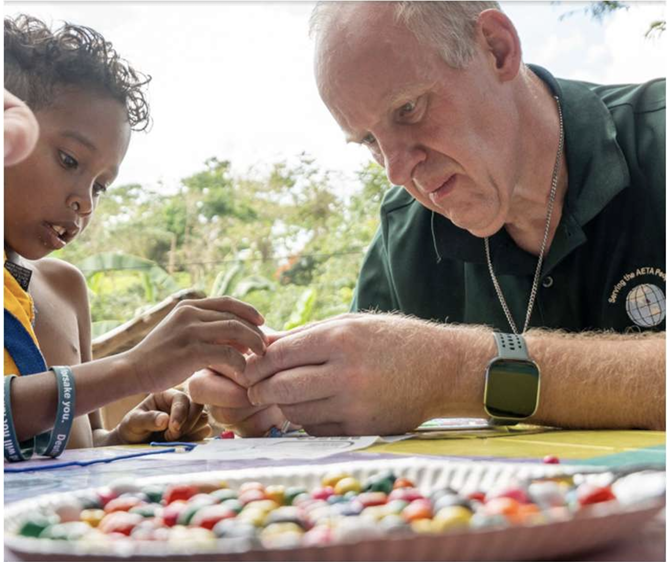 Mission team member working with a child